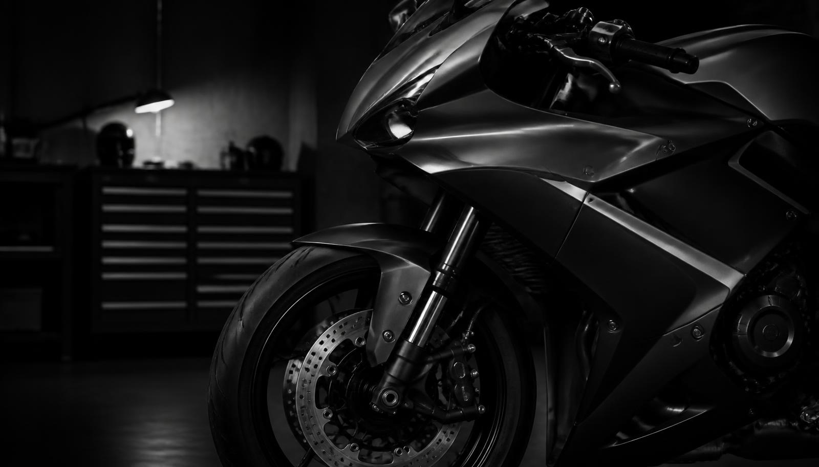 Motorbike with crash damage prepared for accident repair at a Cardiff workshop