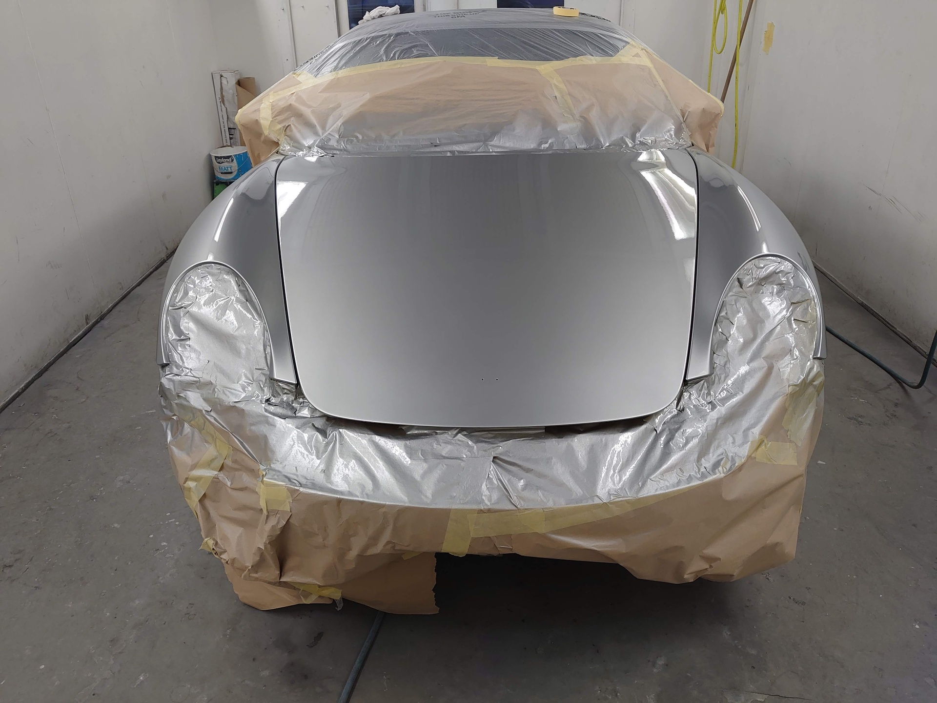 Professional paint preparation and masking on silver car at CJVS Cardiff bodyshop